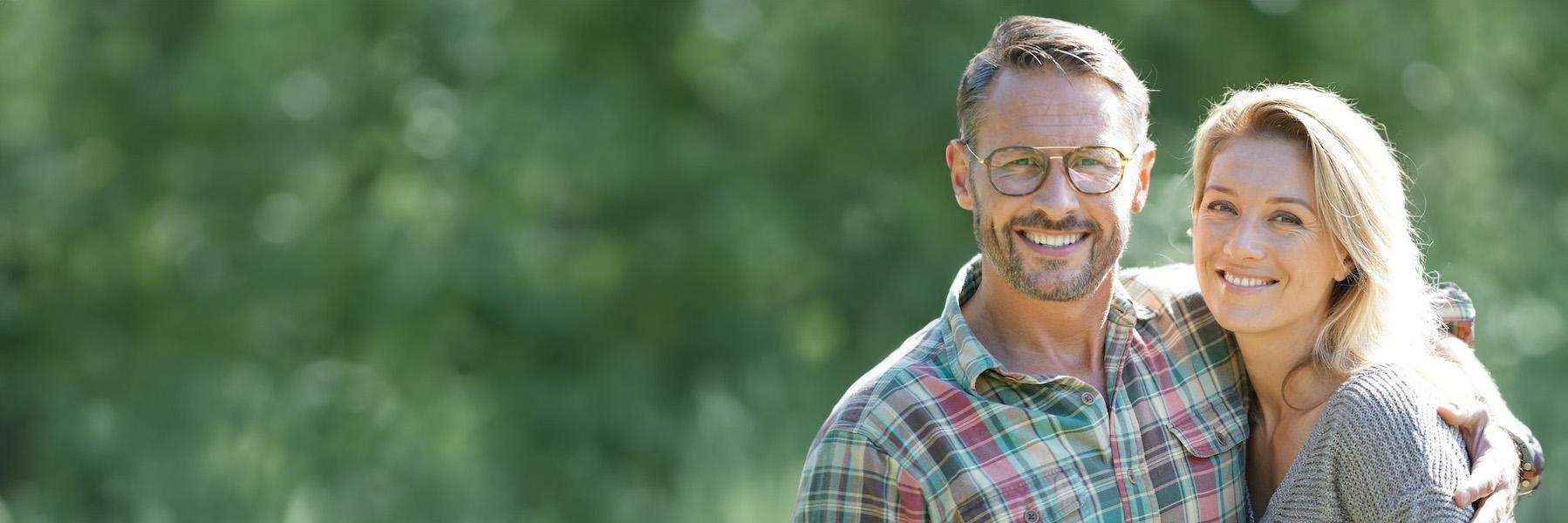 A smiling couple outdoors | dental crowns Coffs Harbour