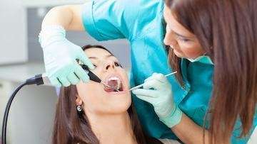 Woman getting a dental exam | Arthur Street Dental