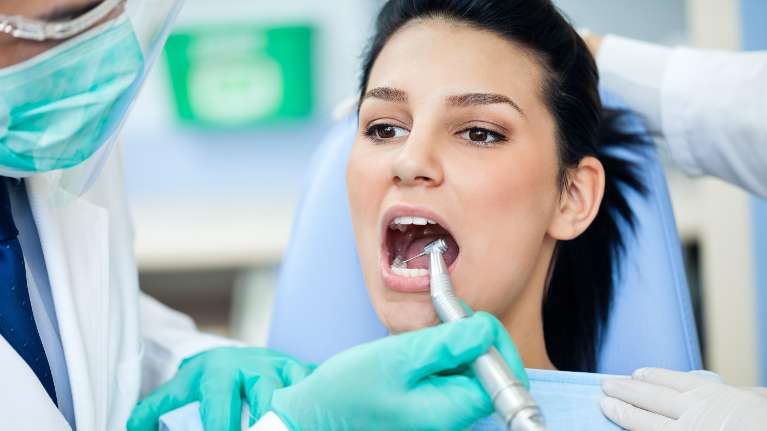 A woman getting her teeth cleaned