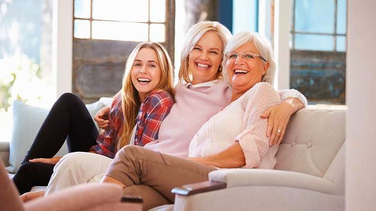 family smiling on the couch