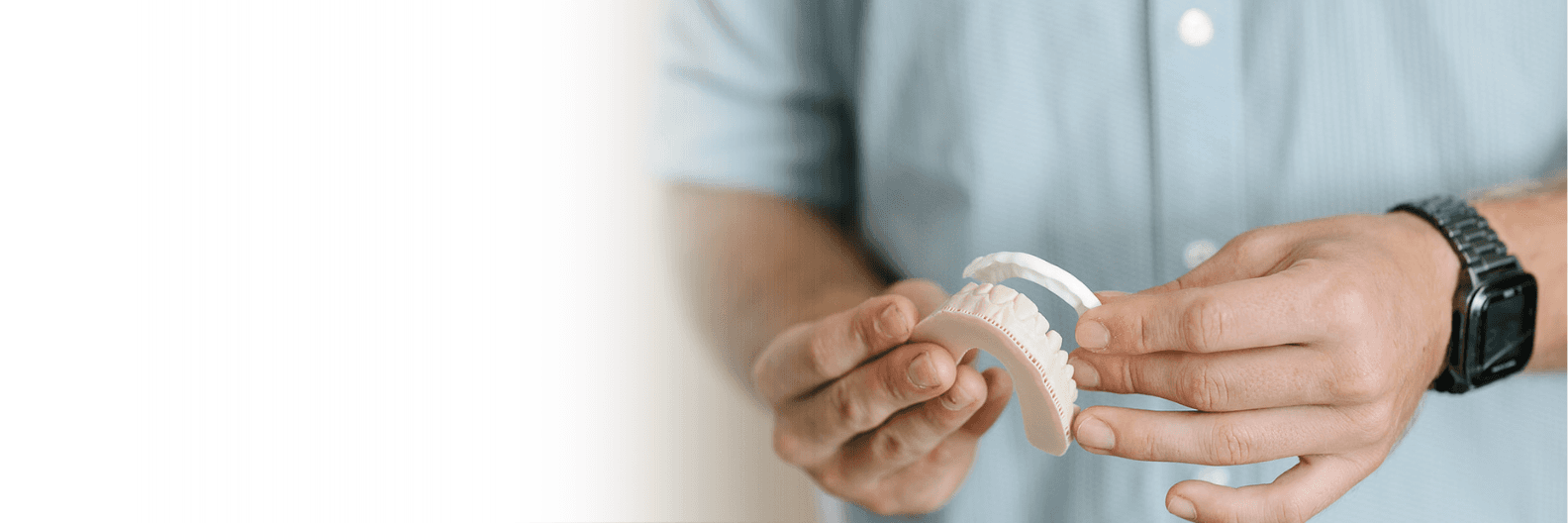 Dentist in Coffs Harbour holding mouthguard