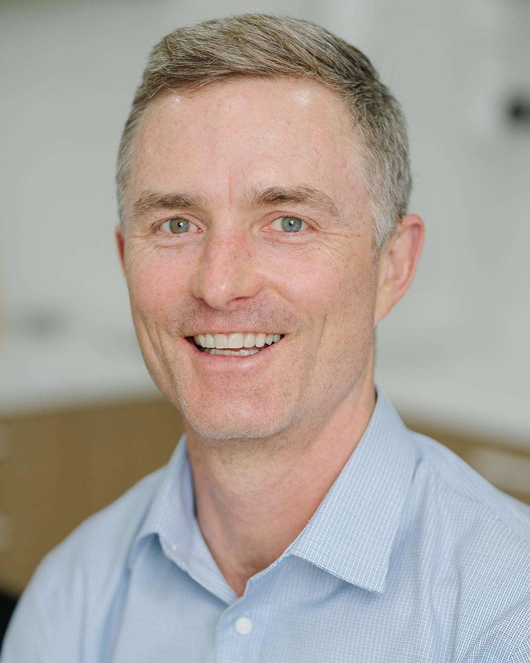 Dr. Justin Ward stands and smiles in our Coffs Harbour NSW dental office